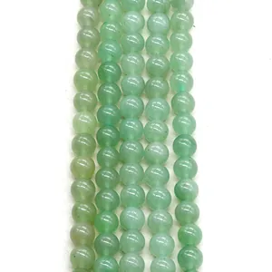 Macro detail of polished green aventurine beads showing natural stone texture for DIY jewelry
