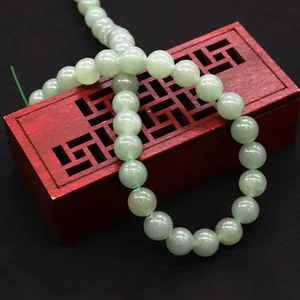 Natural green aventurine beads on wooden box for DIY jewelry making necklaces