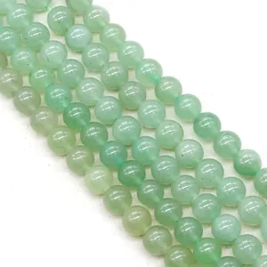 Macro detail of natural green aventurine beads strands with smooth polished texture