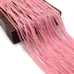 Pink natural stone tube beads for DIY jewelry necklaces on a vintage wooden box