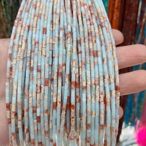 Gros plan de perles cylindriques en lapis et jaspe naturels pour création de colliers