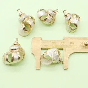 Detail of natural seashell pendant with gold frame measured by brass caliper showing 20mm size