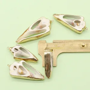 Detail of natural shell pendants with gold plated edges for DIY jewelry making
