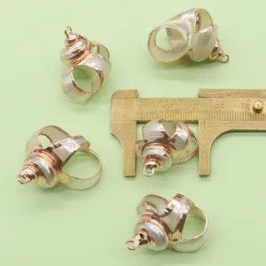 Macro view of natural shell pendant with rose gold plated edges and measurement details