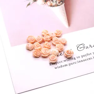 Detailed macro view of pink synthetic coral rose beads for DIY jewelry making and earrings