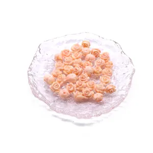 Macro view of delicate pink resin rose flower charms for DIY jewelry making and earring design