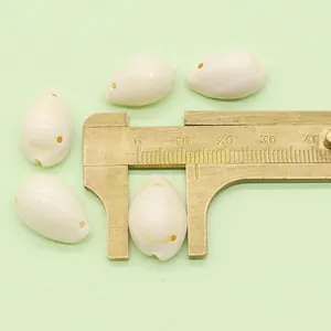 Measuring natural white cowrie shell bead size with brass caliper for DIY jewelry making