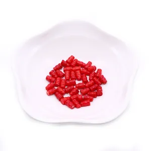 Vibrant red synthetic coral gourd-shaped beads for DIY jewelry making on white dish