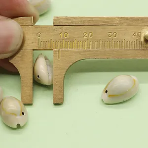 Measuring natural cowrie shell bead 10-12mm for DIY jewelry making with brass caliper