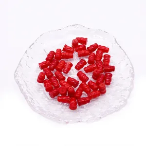 Vibrant red synthetic coral gourd-shaped beads on a textured glass tray for DIY jewelry