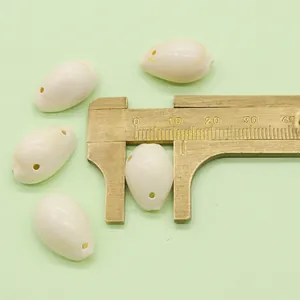 Measuring a 16.5mm polished white shell bead using a brass caliper for DIY jewelry