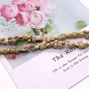 Macro shot of natural shell beads for DIY jewelry making on an artistic card background
