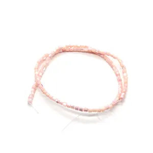 Gros plan de perles carrées en nacre rose polie pour la création de bijoux artisanaux