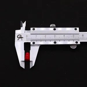 Detail showing the 4.5mm diameter of red synthetic coral gourd beads with a caliper tool