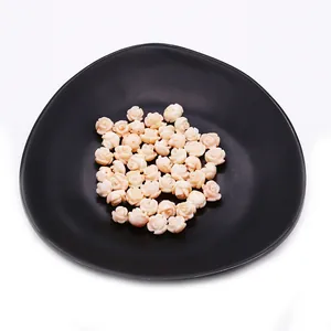 Pink synthetic coral rose flower beads for DIY jewelry making on black display plate