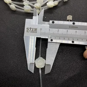 Detailed view of 10mm white shell rose beads measured with a digital caliper for DIY