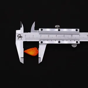 Macro shot showing 1.7cm orange carved coral leaf bead measured with a digital caliper