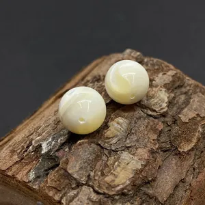 Natürliche runde Perlmuttmuschelperlen für DIY-Schmuck auf Holzgrundlage