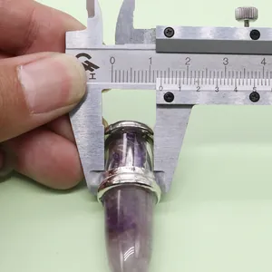 Macro shot of purple natural stone bullet pendant measured at 18mm with a caliper