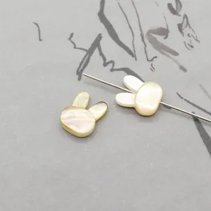Macro detail of rabbit-shaped natural shell beads for DIY jewelry making accessories