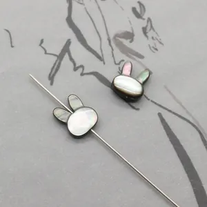 Macro shot of rabbit-shaped black mother of pearl shell beads with iridescent luster