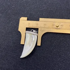 Detail view of natural white shell dagger pendant showing 12mm width measurement