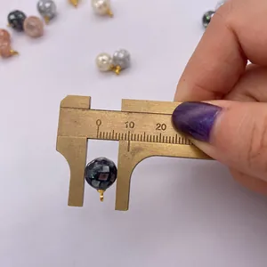 Caliper measuring a 12mm mosaic shell bead pendant for DIY jewelry making necklaces