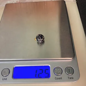 Digital scale showing a 1.25g weight for a mosaic shell pendant with gold metal ring