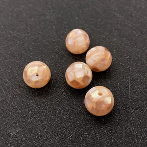 Macro shot of mosaic natural shell beads with soft pink iridescence for DIY jewelry