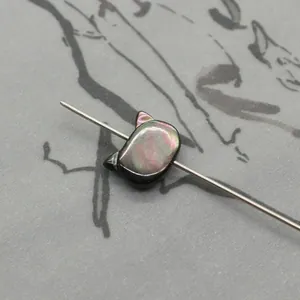 Cat-shaped natural shell bead with rainbow luster on needle for DIY necklace jewelry