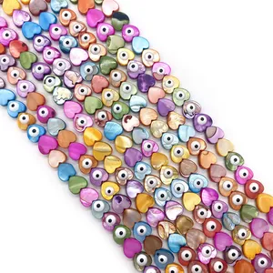 Macro detail of heart-shaped shell beads with evil eye pattern for DIY jewelry