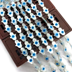 Natural white shell Hamsa hand beads with blue evil eye detail for DIY jewelry