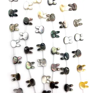 Macro shot of rabbit head shaped natural shell beads showing iridescent luster for jewelry