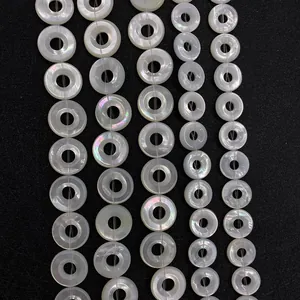 Macro shot of white mother of pearl donut beads with natural iridescent luster for DIY jewelry