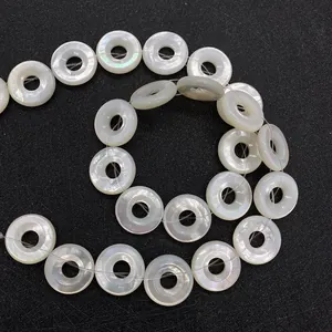 Macro view of natural white mother of pearl ring beads with iridescent luster for DIY jewelry