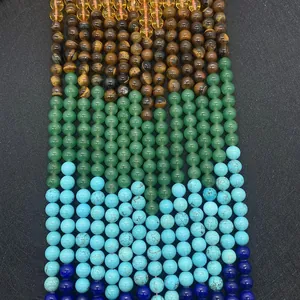 Macro detail of natural tiger eye, lapis lazuli and turquoise round beads in vertical rows