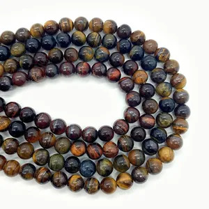 Macro detail of mixed natural tiger eye beads showing smooth texture and cat eye effect