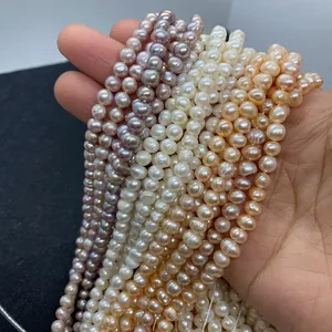 Close-up of white, purple, and orange natural freshwater pearls for DIY jewelry making