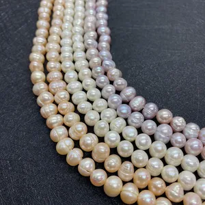 Macro shot of white, pink, and lavender natural freshwater pearls in curved rows