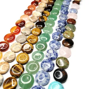 Close-up of polished natural stone coin beads including tiger eye and lapis lazuli