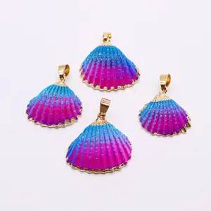 Detailed view of natural shell charms with blue-pink gradient and golden metallic edges