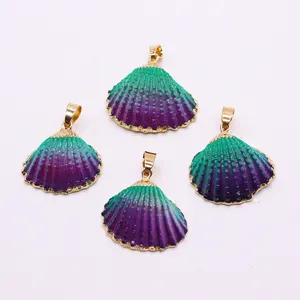 Detailed view of four gradient purple and green seashell pendants with gold plated edges
