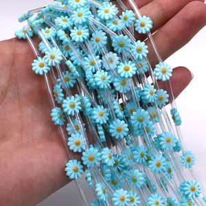 Macro shot of light blue daisy flower shell beads inside clear tubes for DIY jewelry