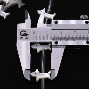 Dettaglio macro di perline a forma di cane da 16mm con lucentezza naturale in madreperla