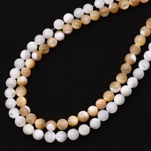 Double-layer necklace with natural seashell round beads in cream and amber hues