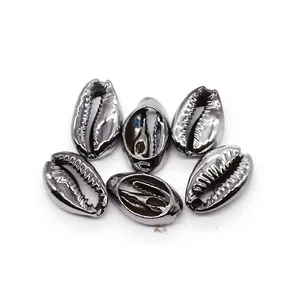 Detailed view of six silver metallic electroplated cowrie shells for DIY jewelry making