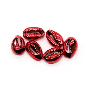 Close-up of six metallic red electroplated cowrie shell beads for DIY jewelry