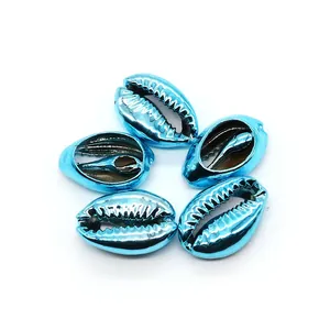 Macro shot of 5 metallic blue electroplated natural cowrie shells for DIY jewelry making