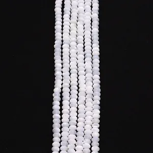 Macro shot of white mother of pearl round beads with natural iridescent luster for DIY jewelry