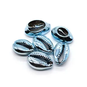 Macro view of six light blue electroplated natural cowrie shells for DIY jewelry crafts